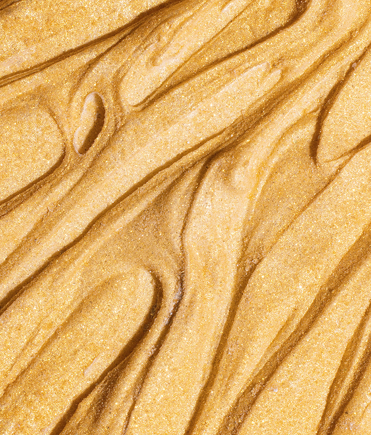 Close-up of Edible Glitter Dust Gold Rush showcasing its shimmering gold texture on a plain background