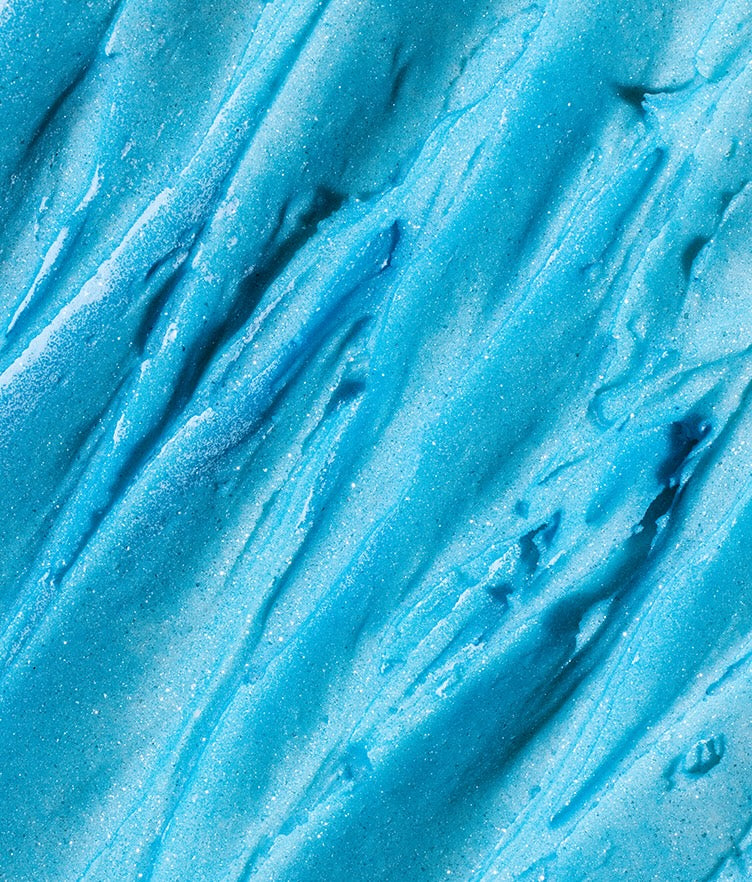 Close-up of Edible Glitter Dust in Neptune Blue showcasing fine blue shimmer with a textured surface