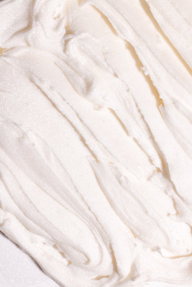 Close up of Edible Glitter Dust Diamond White showcasing fine white shimmer on a plain background