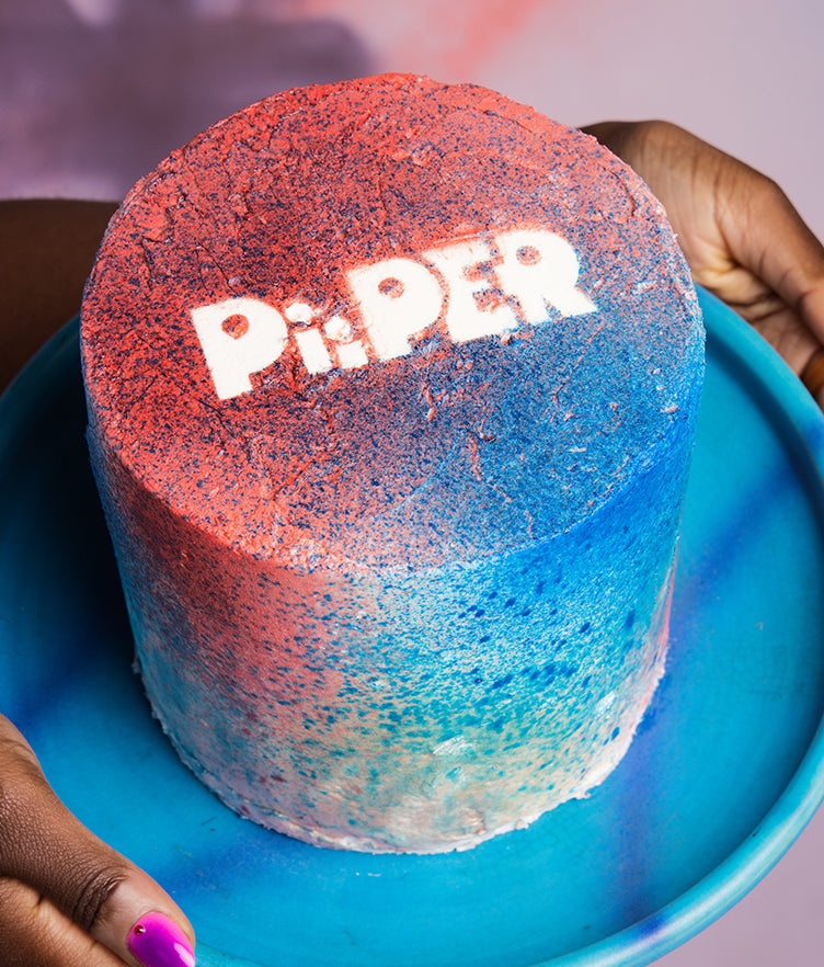 Cake decorated with pink and blue edible Color Spray on a blue plate