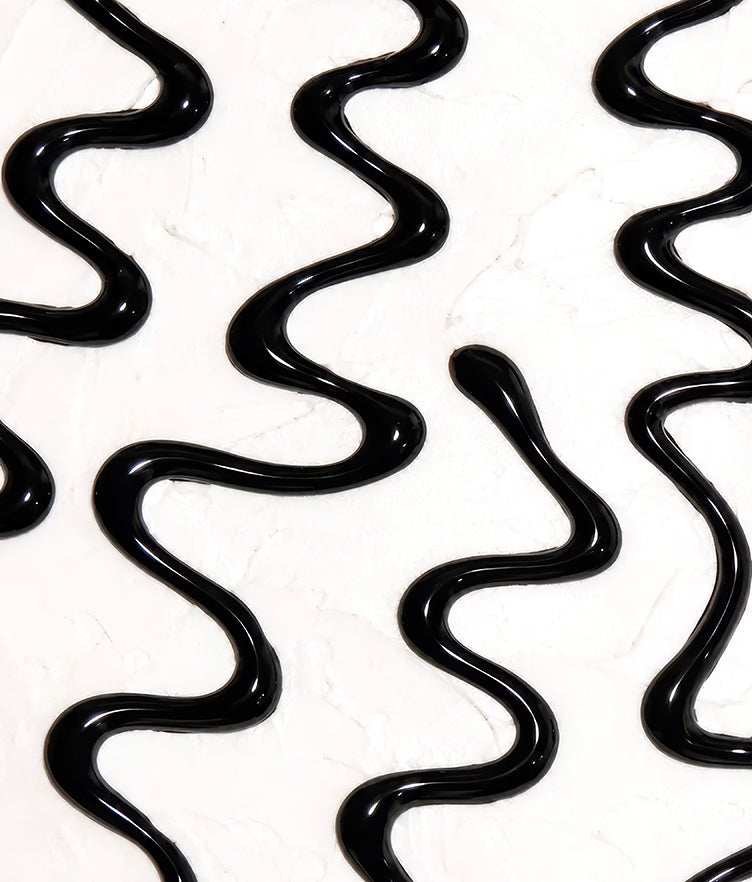 Close-up of black writing gel showcasing glossy, controlled lines on a white surface