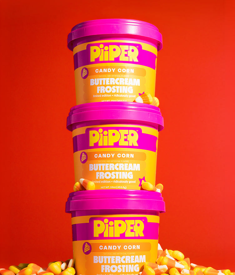 Front view of three PiiPER Candy Corn Buttercream Frosting tubs showcasing colorful packaging with candy corn on a red background