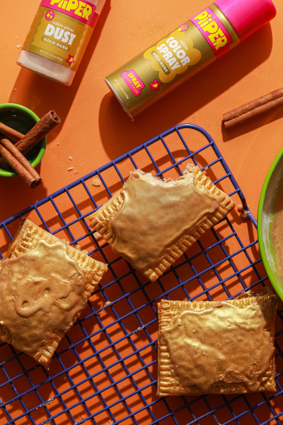 Gold Cinni Roll Tarts finished with PiiPER Gold Rush Edible Glitter Dust and Color Spray